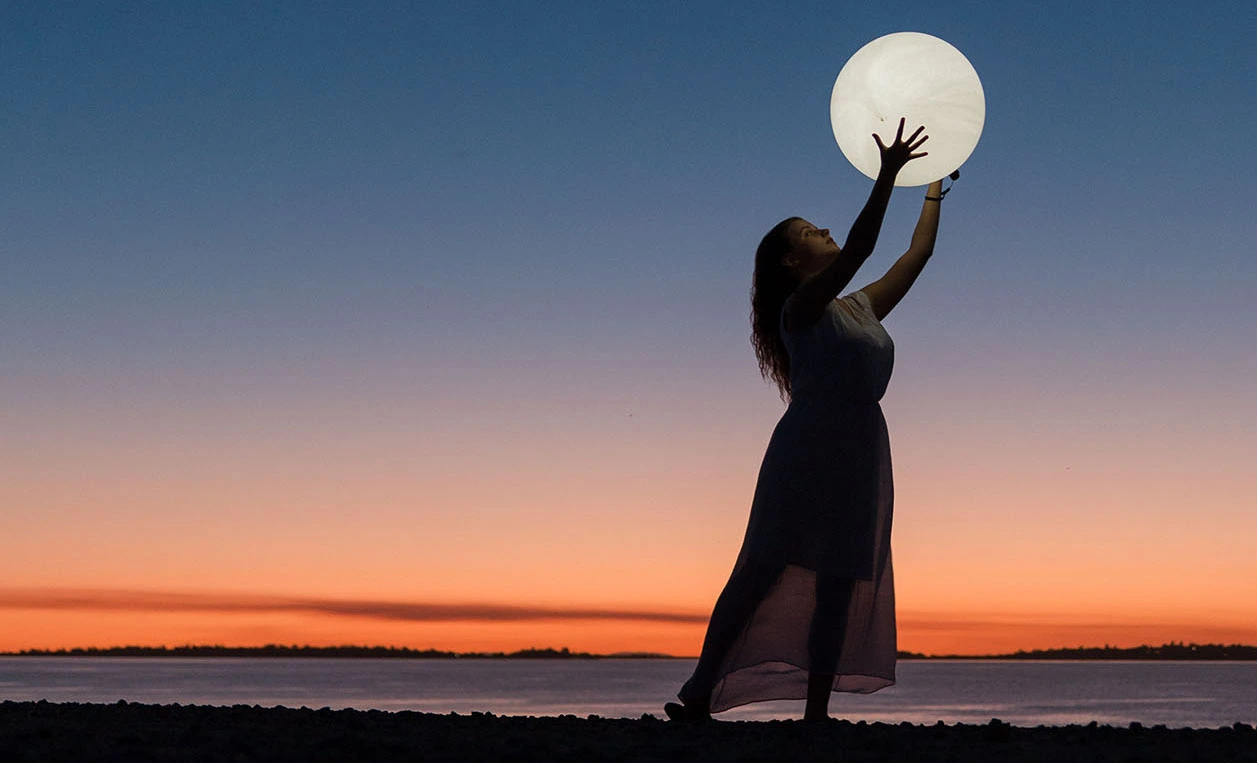 woman holding a moon